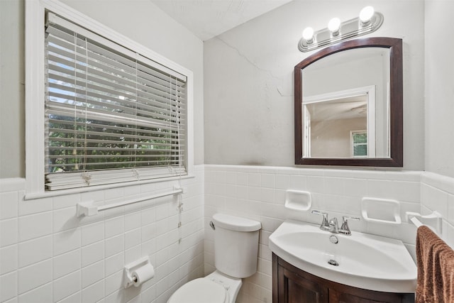 2310 Pecos St, La Marque, TX 77568 - bathroom with toilet, vanity, tile walls, and a wainscoted wall