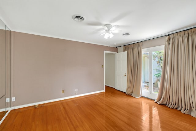 unfurnished bedroom with light wood-style flooring, baseboards, a ceiling fan, and access to exterior