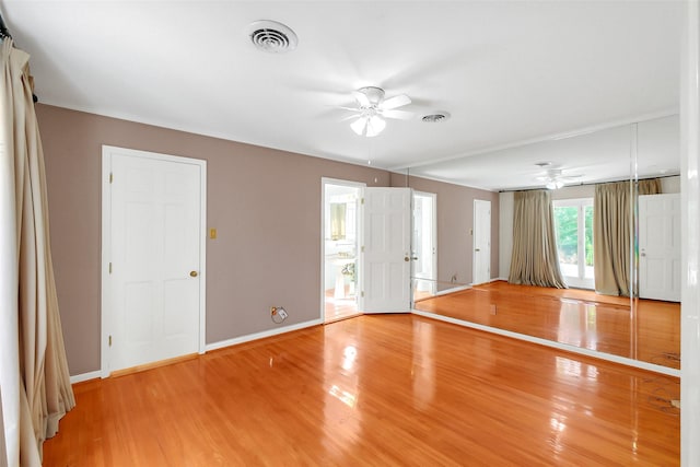 unfurnished room featuring a ceiling fan, light wood finished floors, and baseboards