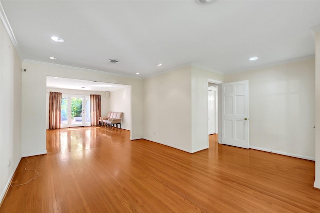 spare room featuring light wood-style floors, ornamental molding, baseboards, and recessed lighting