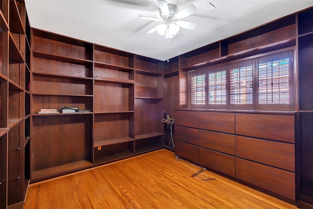walk in closet featuring a ceiling fan and wood finished floors