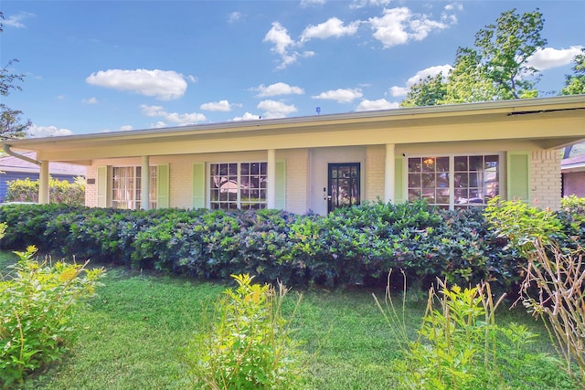 ranch-style house featuring brick siding and a porch