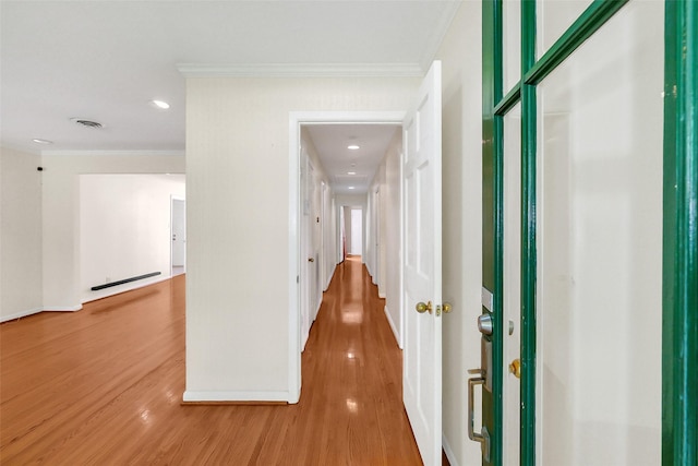 hallway with crown molding, light wood finished floors, and recessed lighting