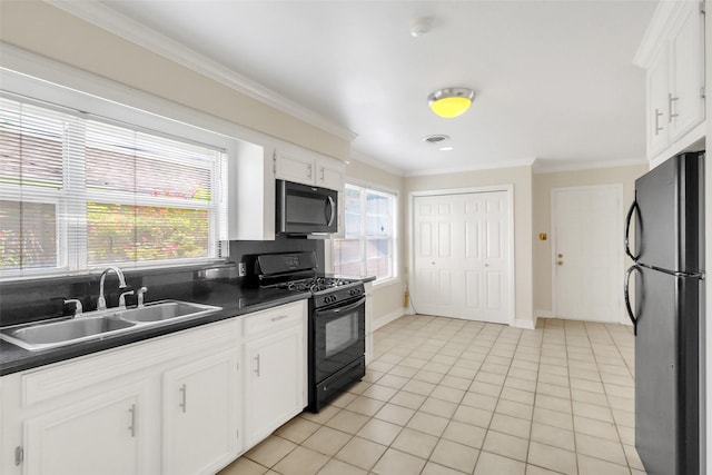 kitchen featuring black appliances, a sink, dark countertops, crown molding, and white cabinetry