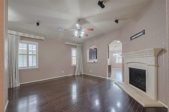 3603 Canvasback Ln, Houston, TX 77047 - unfurnished living room with a ceiling fan, baseboards, a glass covered fireplace, and hardwood / wood-style flooring