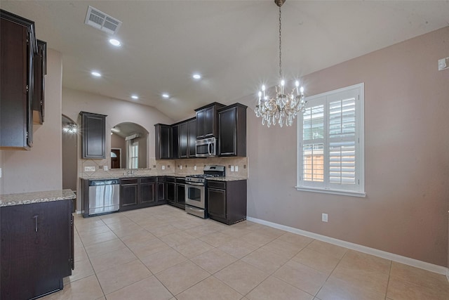 3603 Canvasback Ln, Houston, TX 77047 - kitchen featuring stainless steel appliances, a chandelier, tasteful backsplash, healthy amount of natural light, and lofted ceiling