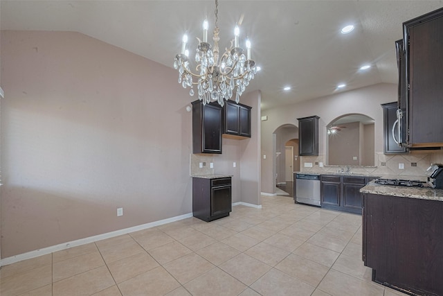 3603 Canvasback Ln, Houston, TX 77047 - kitchen with appliances with stainless steel finishes, vaulted ceiling, arched walkways, decorative backsplash, and a sink