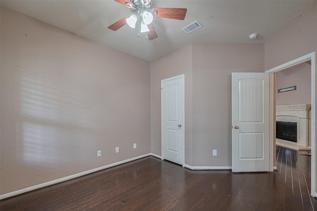 3603 Canvasback Ln, Houston, TX 77047 - unfurnished bedroom featuring wood-type flooring, baseboards, a fireplace with raised hearth, and ceiling fan