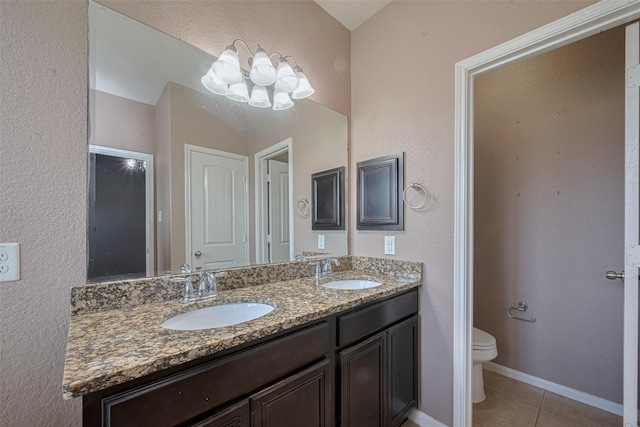 3603 Canvasback Ln, Houston, TX 77047 - full bath with tile patterned floors, double vanity, toilet, and a chandelier