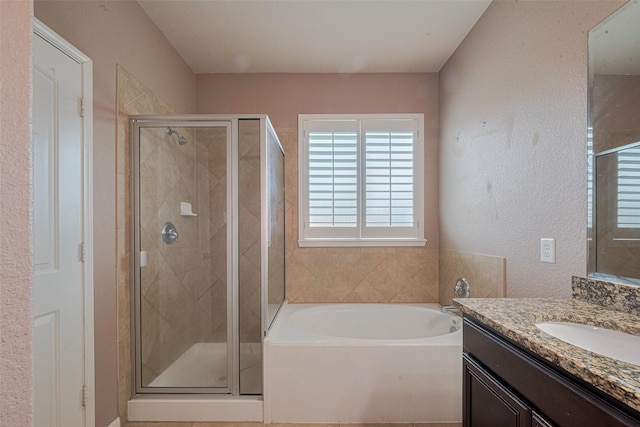 3603 Canvasback Ln, Houston, TX 77047 - bathroom with vanity, a bath, a shower stall, and a textured wall