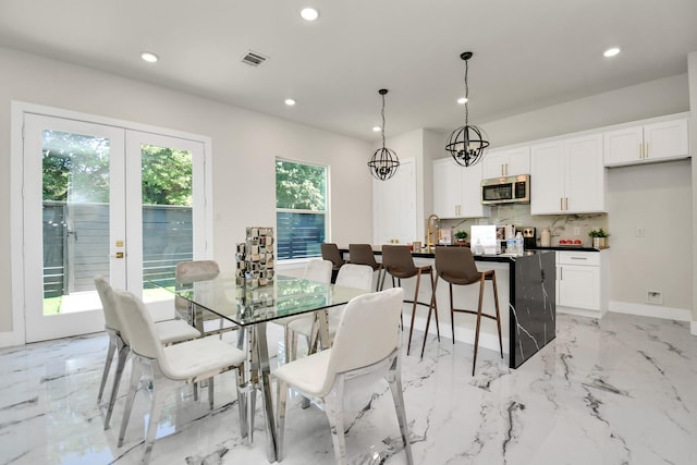 6553 Sealey St, Houston, TX 77091 - dining room with french doors, visible vents, marble finish floor, and recessed lighting