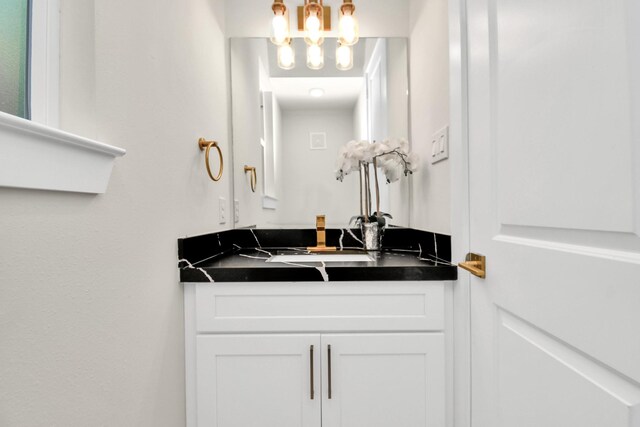 6553 Sealey St, Houston, TX 77091 - bathroom with vanity and a notable chandelier