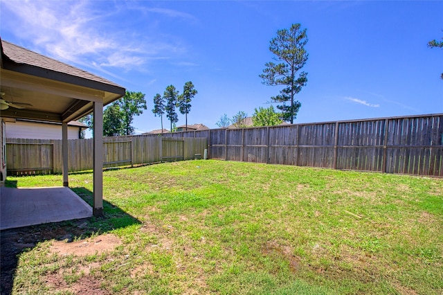 view of yard with a patio area, a ceiling fan, and a fenced backyard