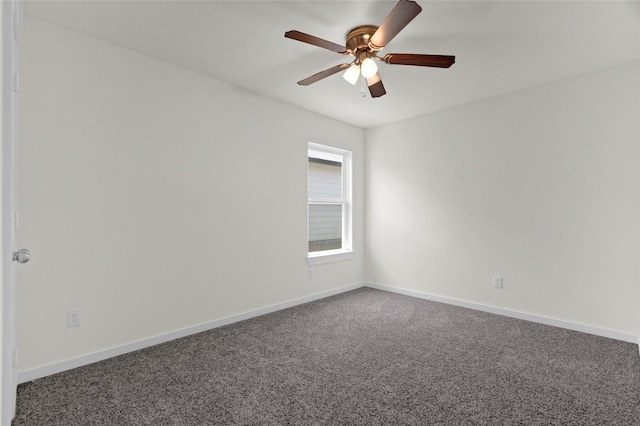 carpeted spare room with ceiling fan and baseboards