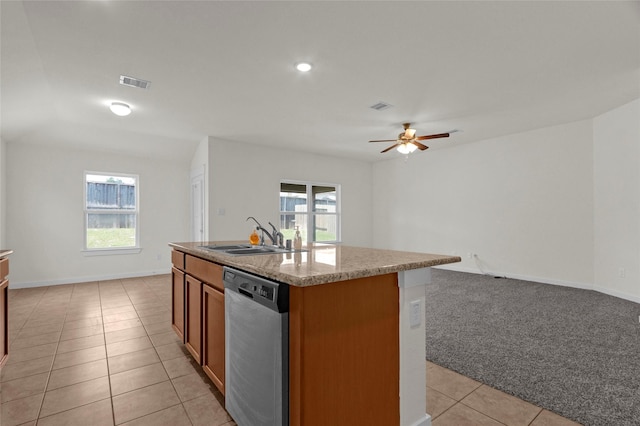 kitchen featuring dishwasher, light tile patterned floors, plenty of natural light, and a sink