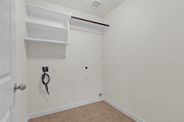 clothes washing area with laundry area, hookup for an electric dryer, visible vents, baseboards, and hookup for a washing machine