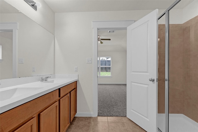full bathroom featuring a sink, a shower stall, a ceiling fan, and tile patterned floors