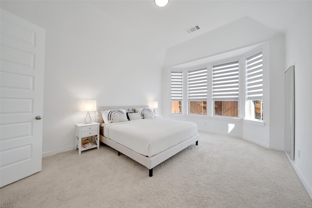 bedroom featuring baseboards, visible vents, and light colored carpet