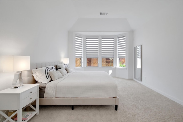 bedroom featuring light colored carpet, baseboards, visible vents, and multiple windows