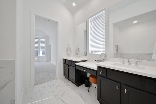 bathroom featuring recessed lighting, marble finish floor, two vanities, and a sink