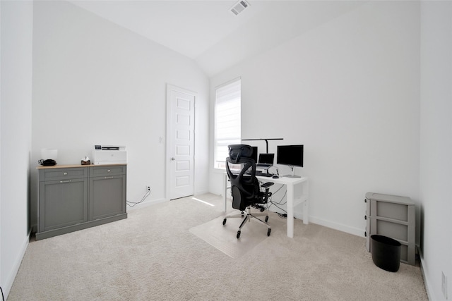 home office with vaulted ceiling, light colored carpet, baseboards, and visible vents