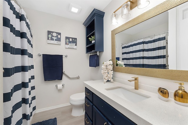 701 Briar Ct, Brownsville, TX 78521 - full bathroom with a shower with curtain, toilet, baseboards, vanity, and wood finished floors