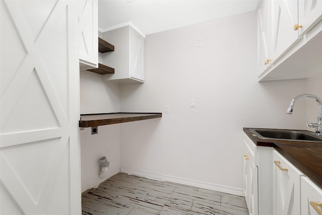 701 Briar Ct, Brownsville, TX 78521 - washroom with a sink, hookup for an electric dryer, and cabinet space