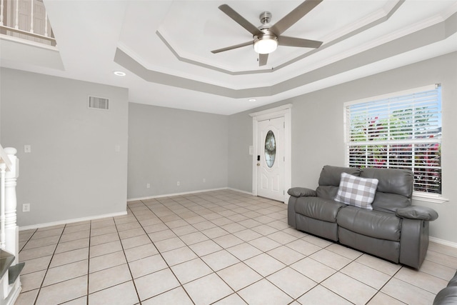 701 Briar Ct, Brownsville, TX 78521 - living room with a ceiling fan, a tray ceiling, visible vents, baseboards, and ornamental molding