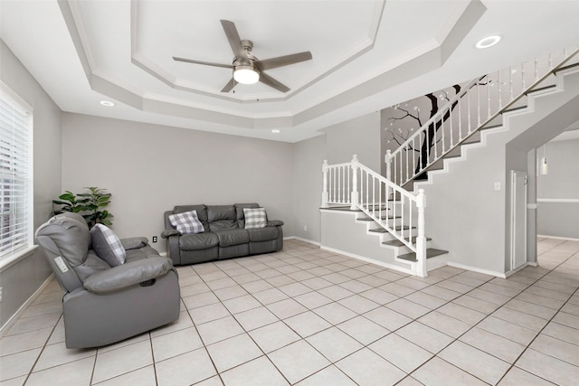 701 Briar Ct, Brownsville, TX 78521 - living area featuring a ceiling fan, stairs, baseboards, and a tray ceiling
