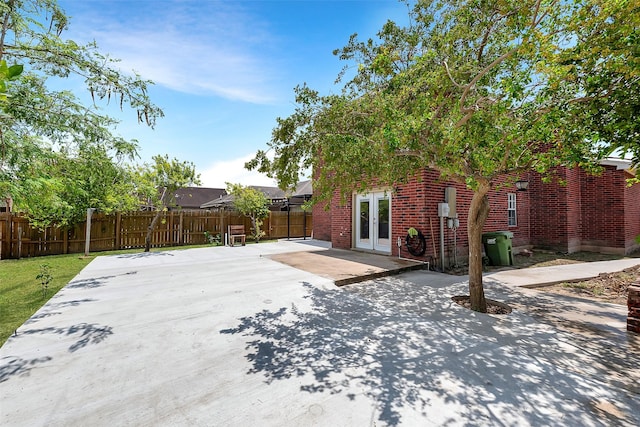 701 Briar Ct, Brownsville, TX 78521 - exterior space featuring a fenced backyard, a patio area, french doors, and brick siding