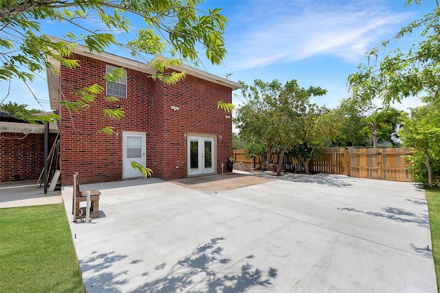 701 Briar Ct, Brownsville, TX 78521 - back of house with fence, french doors, a patio area, and brick siding