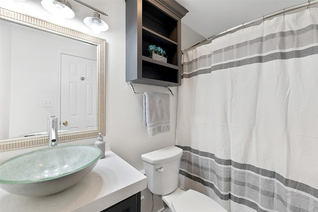 701 Briar Ct, Brownsville, TX 78521 - bathroom with toilet, vanity, and a shower with shower curtain