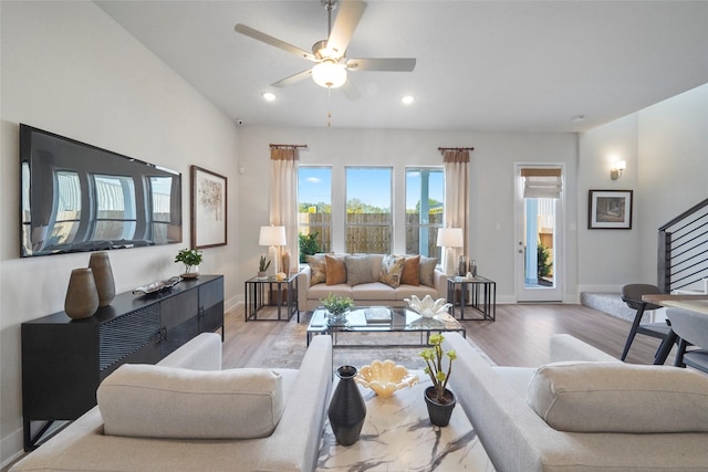 living room with wood finished floors, baseboards, a ceiling fan, and recessed lighting