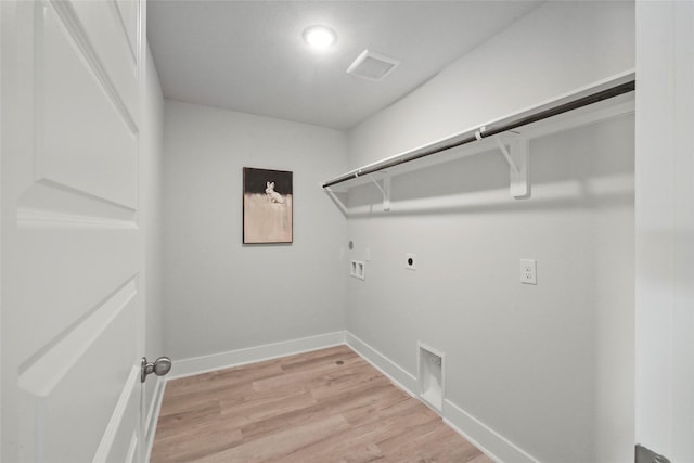 clothes washing area featuring baseboards, gas dryer hookup, light wood-style floors, hookup for an electric dryer, and laundry area