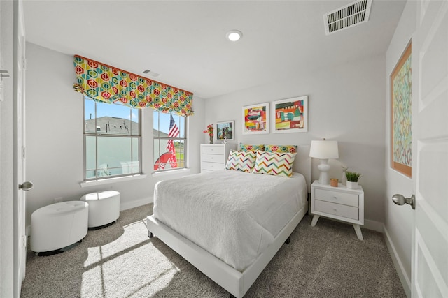 carpeted bedroom featuring baseboards, visible vents, and recessed lighting