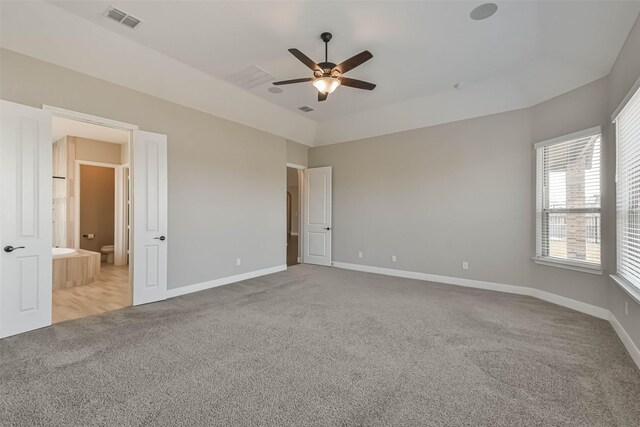 11131 Heartleaf Aster Way, Cypress, TX 77433 - unfurnished bedroom featuring baseboards, ensuite bath, visible vents, and carpet floors