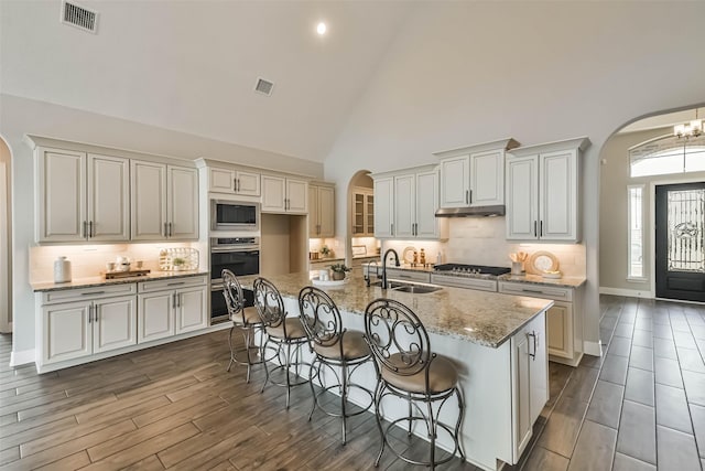 11131 Heartleaf Aster Way, Cypress, TX 77433 - kitchen with a sink, stainless steel appliances, arched walkways, and visible vents
