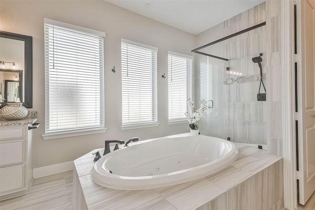 11131 Heartleaf Aster Way, Cypress, TX 77433 - bathroom featuring a stall shower, baseboards, vanity, and a whirlpool tub