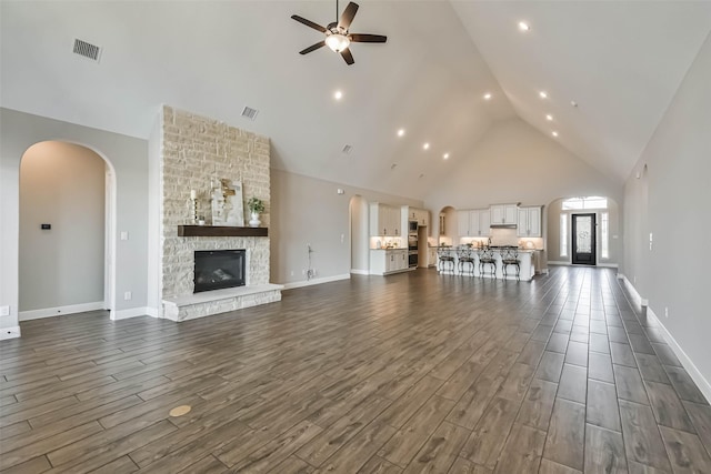 11131 Heartleaf Aster Way, Cypress, TX 77433 - unfurnished living room featuring dark wood-style flooring, visible vents, ceiling fan, and high vaulted ceiling