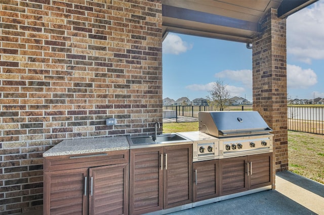 11131 Heartleaf Aster Way, Cypress, TX 77433 - view of patio / terrace with a sink, area for grilling, grilling area, and fence