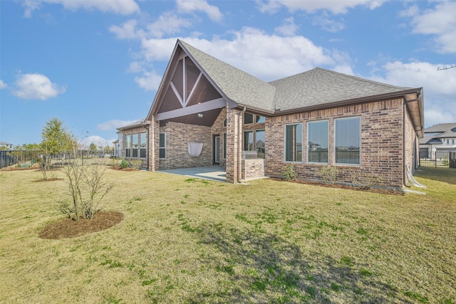11131 Heartleaf Aster Way, Cypress, TX 77433 - back of house featuring a shingled roof, brick siding, fence, and a lawn