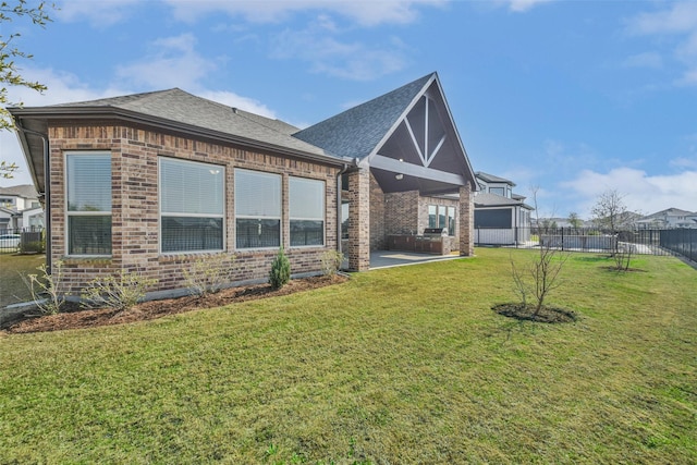 11131 Heartleaf Aster Way, Cypress, TX 77433 - rear view of house with a patio area, fence, brick siding, a lawn, and a shingled roof