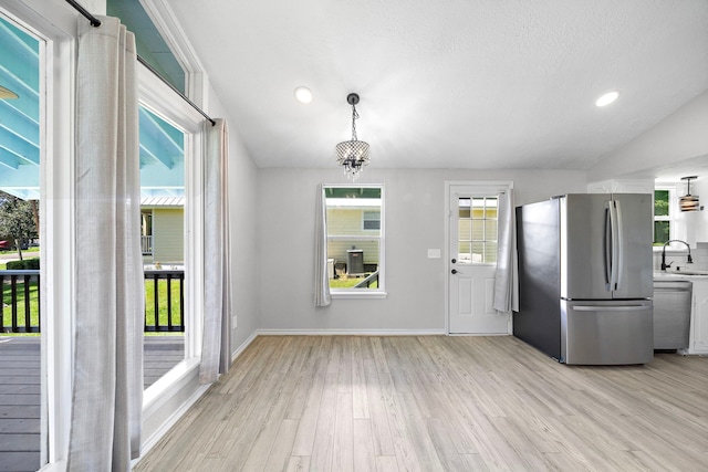 315 Lakeview Hbr, Onalaska, TX 77360 - unfurnished dining area featuring a sink, light wood-style floors, baseboards, recessed lighting, and a chandelier