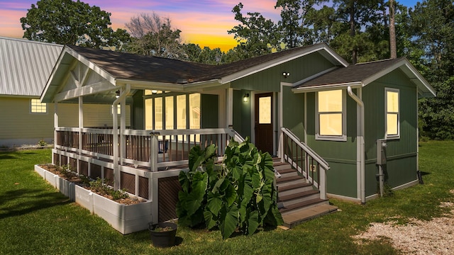 315 Lakeview Hbr, Onalaska, TX 77360 - back of house at dusk with a yard and a shingled roof