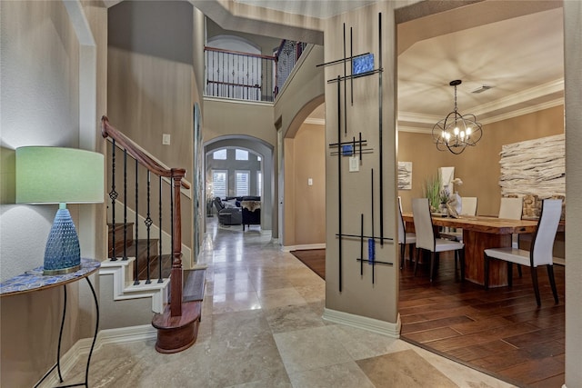 19089 Grandview Pt, Montgomery, TX 77356 - foyer entrance featuring arched walkways, stairs, baseboards, ornamental molding, and a chandelier