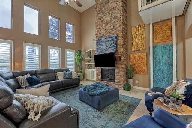 19089 Grandview Pt, Montgomery, TX 77356 - living area featuring a towering ceiling, a ceiling fan, and a fireplace