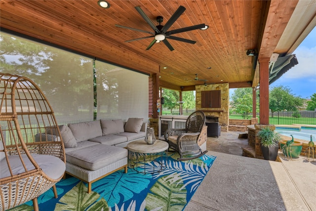 19089 Grandview Pt, Montgomery, TX 77356 - view of patio / terrace with an outdoor living space with a fireplace, ceiling fan, and fence
