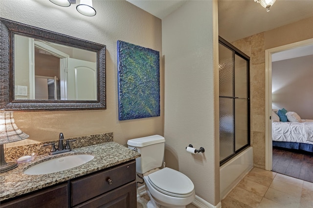 19089 Grandview Pt, Montgomery, TX 77356 - ensuite bathroom featuring toilet, vanity, a textured wall, enclosed tub / shower combo, and baseboards