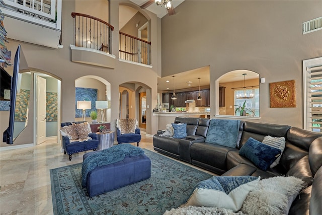 19089 Grandview Pt, Montgomery, TX 77356 - living area featuring a high ceiling, baseboards, arched walkways, a chandelier, and ceiling fan