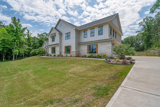 8577 Majestic Lake Ct, Montgomery, TX 77316 - modern farmhouse featuring board and batten siding, stone siding, a front lawn, driveway, and roof with shingles